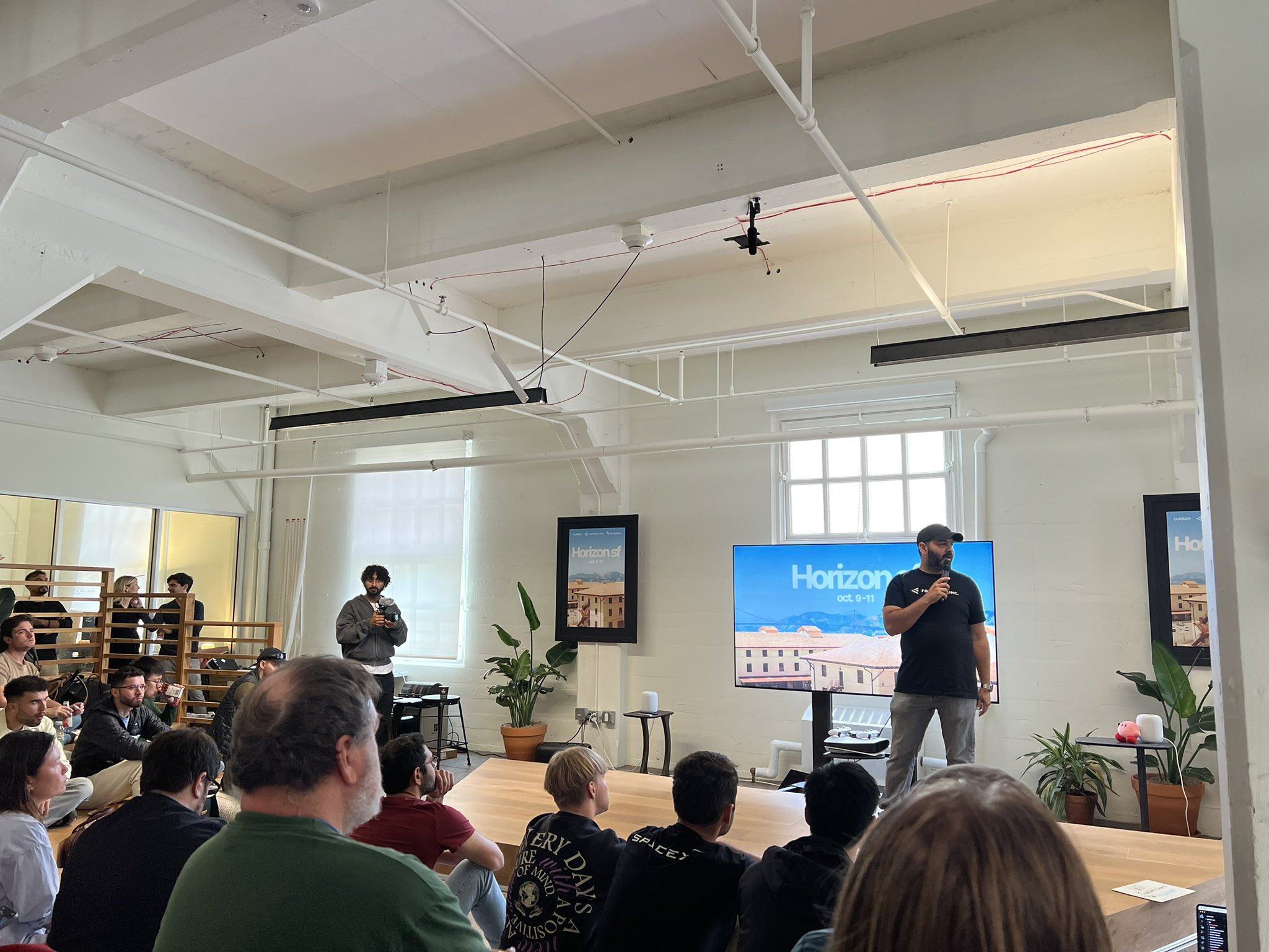 Speaker presenting on stage at a Horizon SF tech event.
