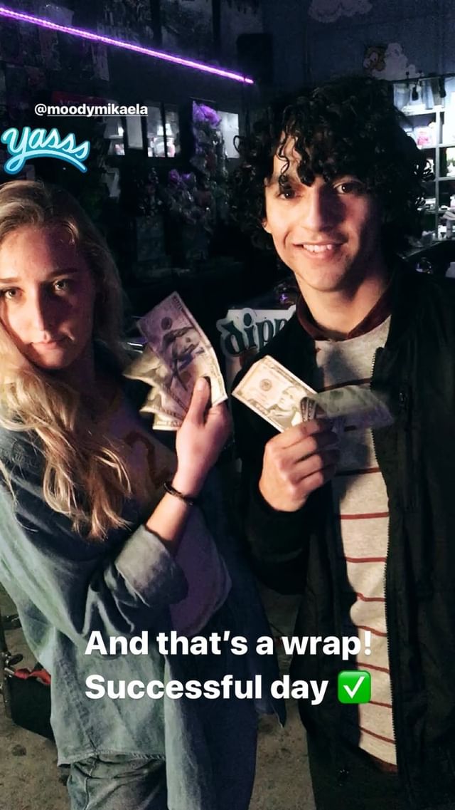 Two people celebrating wrap day on a television set.